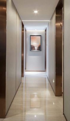 an empty hallway leading to two elevators