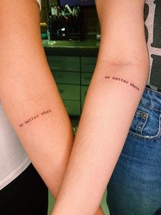 two people with tattoos on their arms holding each other's hands and the words, no matter what