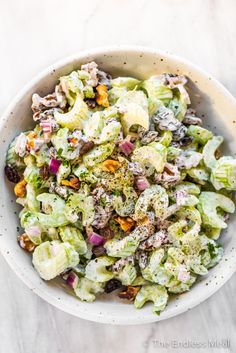 a white bowl filled with salad on top of a table