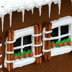 a gingerbread house with icing on the windows