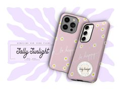 two pink iphone cases with daisies on them and the words stay happy written in cursive writing