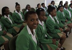 a group of young women sitting next to each other