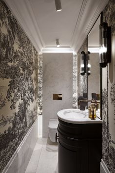 a bathroom with black and white wallpaper on the walls