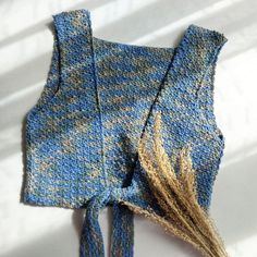 a knitted piece of cloth with some grass in it's middle and the top part showing