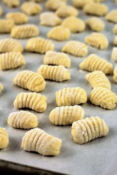 some kind of food that is sitting on a baking sheet and ready to be baked