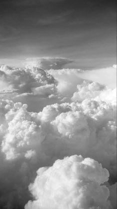 black and white photo of clouds taken from an airplane