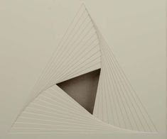 an abstract drawing with lines in the shape of a triangle on a white wall and floor