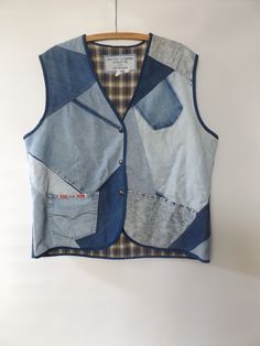 vintage 80s denim patchwork vest - size 3XL on tags - handmade  - snap closure - flannel lining - gender neutral/unisex  - boxy fit top  - oversize  - OOAK - blue jean jacket  - 90s grunge LABEL --  handmade by angelique of rapid city, SD MATERIAL -- cotton denim and flannel CONDITION -- great vintage -- ready to wear MEASUREMENTS IN INCHES size -- 3x on tags shoulder - bottom hem -- 28 chest lying flat/doubled --  50 across upper back -- 19.5 Retro Cotton Patchwork Denim Jacket, Retro Patchwork Denim Jacket, Retro Cotton Denim Jacket With Patchwork, Casual Denim Patchwork Vest, Blue Cotton Retro Denim Vest, Blue Retro Cotton Denim Vest, Retro Blue Cotton Denim Vest, Casual Cotton Denim Vest With Patchwork, Medium Wash Patchwork Denim Vest