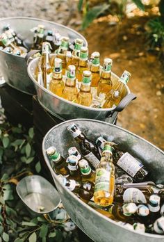 two metal buckets filled with beer bottles