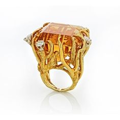 Transport yourself back to the glamorous era of the 1970s with our exquisite 18K Yellow Gold Citrine and Diamond Ring. This stunning piece captures the essence of the time, exuding elegance and sophistication.At the heart of this ring is a breathtaking 117-carat citrine, radiating warmth and capturing the golden hues of the sun. The vibrant gemstone is beautifully complemented by approximately 2 carats of dazzling diamonds, which dance and sparkle with every movement. The diamonds frame the citr Luxury Yellow Open Ring Jewelry, Exquisite Gold Rings For Evening, Exquisite Yellow Gold Rings For Evening, Luxury Brilliant Cut Citrine Diamond Ring, Luxury Evening Rings With Gemstone, Yellow Gold Gemstone Rings For Evening, Exquisite Evening Gemstone Rings, Luxury Topaz Ring With Prong Setting, Luxury Gold Topaz Ring