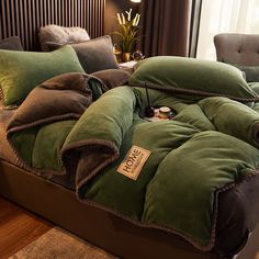 a bed with green and brown pillows on top of it