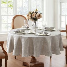 a dining room table set with place settings