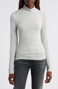 This trim turtleneck is made from sheer and stretchy fabric designed to layer beautifully under all your closet favorites. Turtleneck Long sleeves Sheer 93% modal, 7% spandex Machine wash, dry flat Imported Gray Fitted High Neck Tops, Fitted Gray High Neck Tops, Fitted High Neck Gray Tops, Stretch Mock Neck Top With Fine Knit Long Sleeves, Stretch Fine Knit Long Sleeve Mock Neck Top, Fine Knit Long Sleeve Mock Neck Top For Layering, Stretch Fine Knit Mock Neck Top With Long Sleeves, Versatile Long Sleeve Elastane Top, Fitted Long Sleeve Modal Top