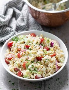 a white bowl filled with rice and vegetables