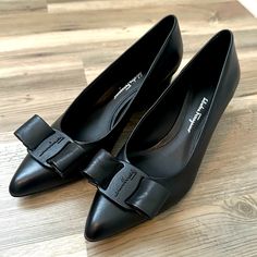 Salvatore Ferragamo Viva Bow Pumps Black Size 8 Great Condition But Not New Please See Photos For Any Minor Flaws. I Have Never Worn Them Out Only Tried On At Home. No Original Box Feel Free To Message With Any Questions! Black Low Heel With Leather Lining, Black Low Heel Heels With Leather Lining, Black Calf Leather Low Heel Heels, Black Calf Leather Court Shoes For Work, Black Calf Leather Low Heels, Black Calf Leather Evening Shoes, Classic Black Court Shoes With Pointed Toe, Black Calf Leather Heels For Business, Black Leather Shoes With Pointed Toe And Removable Insole