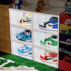 a display case filled with assorted nike shoes on top of green carpeted floor