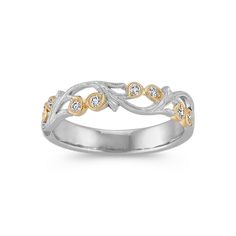 a white and yellow gold ring with diamonds on the sides, set in two tone gold