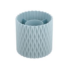 a light blue vase sitting on top of a white table next to a cup holder