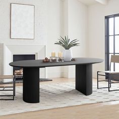 a dining room table with chairs and a potted plant