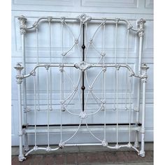 an antique white iron bed frame