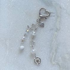 a rosary with charms on it laying in the snow