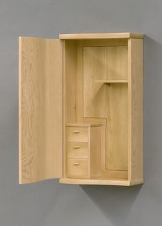 an open wooden cabinet on the wall