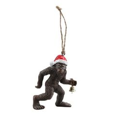 a christmas ornament with a monkey holding a bell