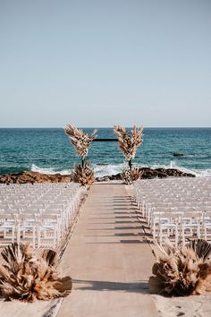 an outdoor ceremony set up on the beach