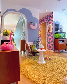 a living room with a pink flamingo on the rug and other furniture in it