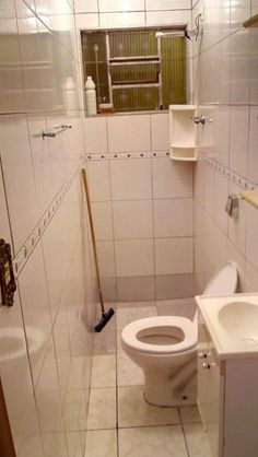 a bathroom with a toilet, sink and shower stall is seen in this image taken from the doorway