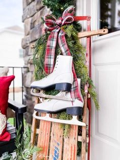 skates are stacked on top of a sled with christmas wreath and decorations around them