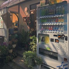 a vending machine in front of a store filled with plants and water bottles on display