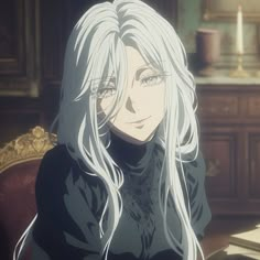 a woman with long white hair sitting at a table in front of an open book