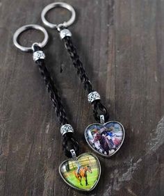 two heart shaped key chains with horses on them