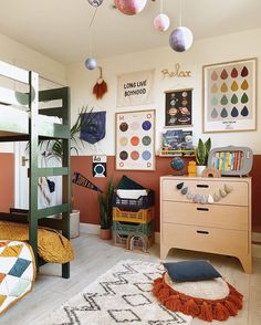 a bedroom with bunk beds, rugs and pictures hanging on the wall above them