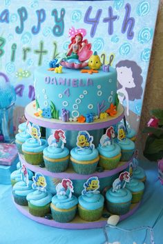 a little mermaid birthday cake and cupcakes