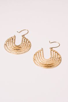 Reflecting a modern organic shape these beautiful gold hoop earrings are a fine investment in style. The hammered finish creates a unique texture that reflects the light and add a three-dimensional look. Materials: Alloy,18K Gold Plating Dimensions: Hangs 2", 1.5" wide Ships in a branded jewelry pouch and box, perfect for gift giving!