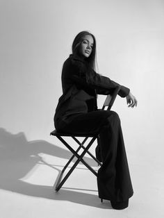 a black and white photo of a woman sitting in a chair