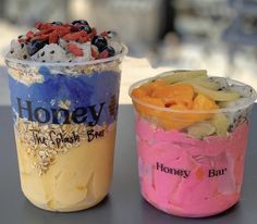 two cups with different types of desserts in them sitting on a table next to each other