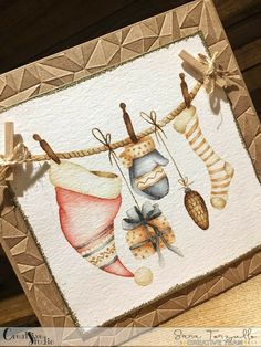 a card with some stockings hanging on a clothes line and other items attached to it