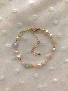 Bracelet Length: 6-8.5inches  Each Bracelet has a 2.5 inch gold filled extender This bracelet  features an assortment of pastel seed bead colors and 24k shiny and matte gold plated seed beads. It also contains freshwater Pearls, pink & white river shell, amazonite, and an assortment of glass crystals. ✨ Seed Bead Size: 11/0, 4mm Spring Gold Jewelry With Colorful Beads, Spring Jewelry With Colorful Beads In Gold, Spring Gold Jewelry With Round Beads, Spring Festival Gold Jewelry With Round Beads, Spring Gold Beaded Bracelets With Colorful Beads, Gold Round Beads Bracelets For Spring, Gold Round Beads Bracelet For Spring, Gold Bracelets With Round Beads For Spring, Dainty Colorful Beaded Jewelry For Spring