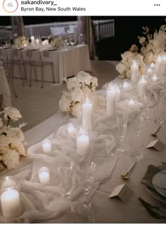 a long table with white flowers and candles