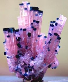 some pink and black rocks on a table