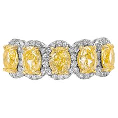 A color-rich ring showcasing vibrant and intense oval cut yellow diamonds, each surrounded by a single row of round brilliant diamonds. Yellow diamonds weigh 2.51 carats total, VS in Clarity. White diamonds weigh 0.25 carats total, F Color and VS in Clarity. Made with 18K Yellow Gold and Platinum, Size 6.5 US resizable upon request. Roman Malakov is a custom house, specializing in creating anything you can imagine. If you would like to receive a special quote on a custom piece please message or Yellow Jewelry, Brilliant Diamond, Oval Cut, Yellow Diamond, Round Brilliant, Diamond White, Platinum, Jewelry Rings, Yellow Gold