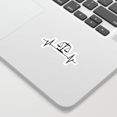 a laptop computer with a sticker on the keyboard