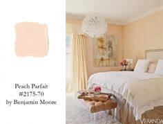 a bedroom with peach paint and white bedding