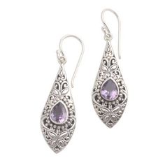 These pretty dangle earrings from Dewi Putera in Bali showcase all that is traditional to Balinese jewelry including the motifs known as jawan (tiny silver granules or dots) and bun (curled silver wire). The leaf-like shapes even call to mind the kawung motif one of the oldest Javanese batik motifs. Sparkling drops of amethyst grace the dangle earrings. Purple Earrings With Intricate Design As Gift, Purple Earrings With Intricate Design For Gift, Ornate Purple Sterling Silver Earrings, Traditional Silver Drop Jewelry, Traditional Purple Drop Earrings, Traditional Sterling Silver Drop Jewelry, Traditional Engraved Teardrop Earrings, Elegant Purple Jewelry For Festivals, Traditional Purple Teardrop Jewelry