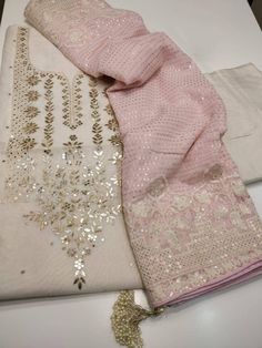 Item Overview ATHARVA Salwar Kameez/Beautiful Hand Embroidery Neck White Chanderi Pink Georgette Dupatta/Heavy Sequence work/Tassels/Plazzo/Gift/Custom Stitch Unstitch  Dno. GE9001 Fabric:  * Shirt Chanderi Silk- White 2.5 Mts, with Beautiful Hand Embroidered Neck. * Dupatta: Georgette Dupatta in Pink All over Sequence work and embroidery on side with Elegant Moti Latkans/ Tassels  * Bottom White Santoon Silk 2.5 Mts. Excusive Hand Embroidered Party Wear Punjabi Suit. 🌷CUSTOMIZATION (No Extra C Suites Designs, Gotapatti Work, Zardozi Work, Trend Fabrics, Gotta Patti, Punjabi Outfits, Indian Designer Suits, Georgette Dupatta, Pakistani Fashion Party Wear