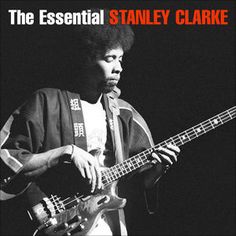 a man playing a bass guitar on stage with the words, the essential stanley clarke