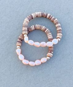 This Beautiful bracelet features natural beachy coconut shell and blush freshwater pearls with 14k gold filled beads that are no tarnish. This bracelet looks great alone or stack with other bracelets! This bracelet is a definite summer go to accessory! One Standard size 7in. Stretch style bracelet  BRACELET CARE INSTRUCTIONS: *Keep jewelry away from humidity and water *Avoid contact with makeup, perfume, lotion and other chemicals.  *Remove before sleeping and any other excise.  *Wipe clean with Beachy Jewelry Boho, Beachy Bracelets, Perfume Lotion, Beachy Jewelry, Boho Beachy, Shell Bracelet, Coconut Shell, Jewelry Boho, Keep Jewelry